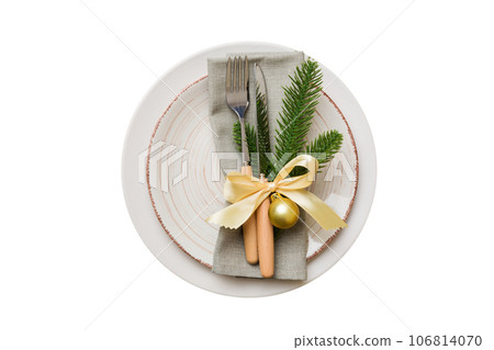 isolated christmas Plate with decor and fork and spoon. New year holiday background. Top view 106814070