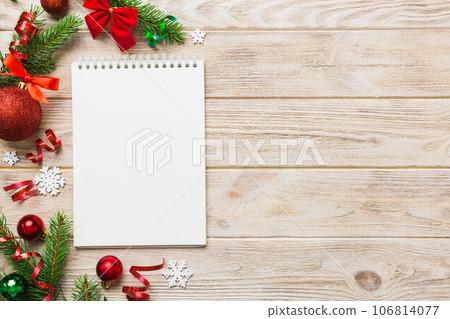 Christmas blank greeting card mock-up scene. Creative layout made of Christmas tree branches and paper card note. Flat lay. Nature New Year concept 106814077