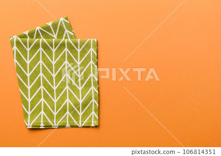 top view with green kitchen napkin isolated on table background. Folded cloth for mockup with copy space, Flat lay. Minimal style 106814351