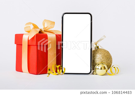 Digital phone mock up with rustic Christmas decorations for app presentation with empty space for you design. Christmas online shopping concept. Tablet with copy space on colored background Digital phone mock up with rustic Christmas decorations for app presentation with empty space for you design. Christmas online shopping concept. Tablet with copy space on colored background 106814483