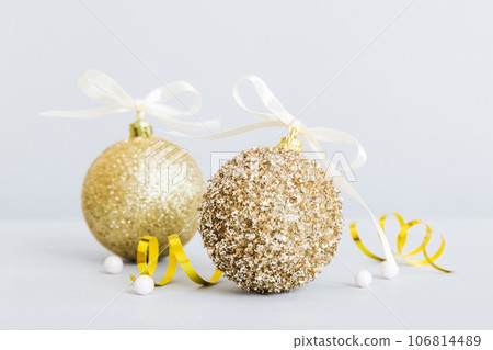 Christmas ball on colored background. decoration bauble with ribbon bow with copy space Christmas ball on colored background. decoration bauble with ribbon bow with copy space 106814489