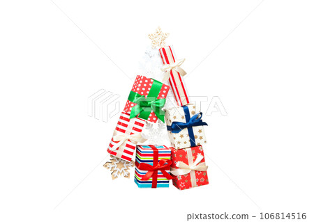 Isolated Christmas tree made of beautifuly wrapped presents on colored background, view from above. New Year gift box minimal concept 106814516