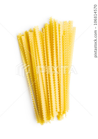 Uncooked mafaldine pasta. Raw long mafalda pasta isolated on white background. 106814570