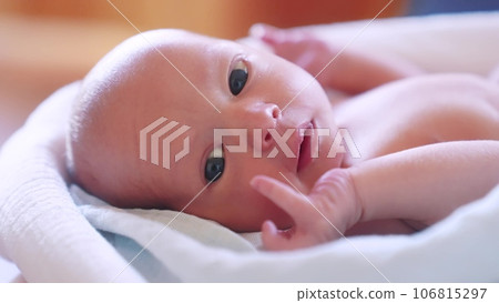 newborn. baby newborn a close-up lies looking at the camera in the hospital maternity hospital. lifestyle happy family baby dream concept. cute newborn baby wrapped in a blanket newborn. baby newborn a close-up lies looking at the camera in the hospital maternity hospital. lifestyle happy family baby dream concept. cute newborn baby wrapped in a blanket 106815297