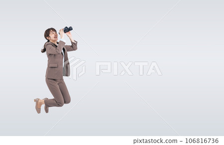 Middle-aged woman jumping with binoculars Middle-aged woman jumping with binoculars 106816736
