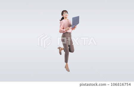 Middle-aged woman jumping while using a laptop 106816754