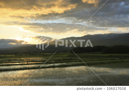 Rice terraces, Niseko mountain range, and sunset seen from Tomioka, Rankoshi Town Rice terraces, Niseko mountain range, and sunset seen from Tomioka, Rankoshi Town 106817038