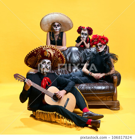Halloween Family. Father playing on guitar, mother and children in halloween skeleton spooky makeup. trick or treat. Halloween traditions. 106817824
