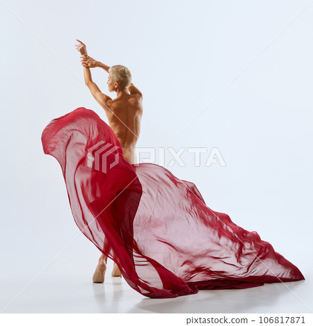 Poster. Rear view portrait of young naked woman covering with bright red floating fabric on her hips, buttocks. Ad. 106817871