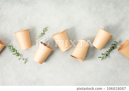 Flat lay composition with eco-friendly paper cups on grey stone background Flat lay composition with eco-friendly paper cups on grey stone background 106818087