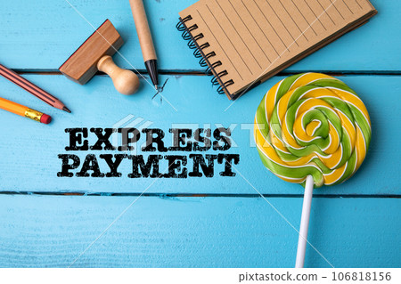 Express Payment. Office supplies on a blue wooden texture table Express Payment. Office supplies on a blue wooden texture table 106818156