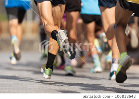 Marathon runners running on city road, large group of runners 106818648
