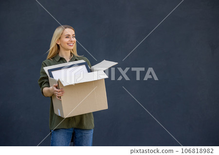 Cute blonde young woman carrying boxes in hands 106818982