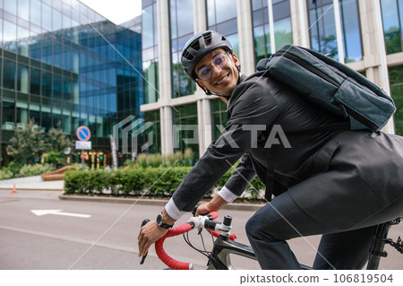 Young man riding a bike in a city center 106819504