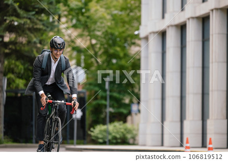 Young manager comuting to the office by electic scooter Young manager comuting to the office by electic scooter 106819512