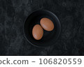 Organic brown raw eggs on black bowl. 3d illustration. 106820559