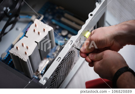 Technician repairing computer power supply closeup, Computer disassembly 106820889