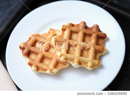 Fresh delicious homemade waffles on white plate 106820890