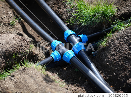 PVC pipeline in garden and black pipes in ground PVC pipeline in garden and black pipes in ground 106820925