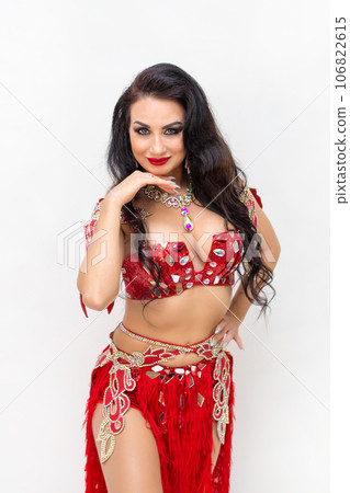 Bright beautiful brunette woman in dancing clothes on a white background, studio photo shoot 106822615