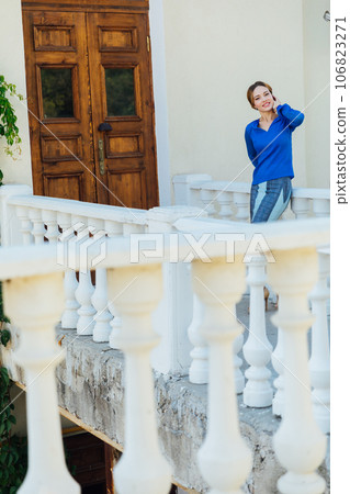 a woman in blue clothes stands at the door of the front door a woman in blue clothes stands at the door of the front door 106823271