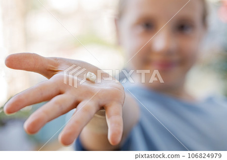Fallen baby tooth in hand of happy little girl. The concept of hygiene of baby teeth Fallen baby tooth in hand of happy little girl. The concept of hygiene of baby teeth 106824979