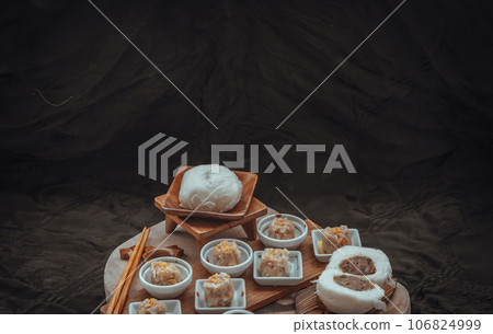 Steamed buns with minced pork filling and Pork shumai or Chinese steamed dumpling served with sour sauce. Steamed buns with minced pork filling and Pork shumai or Chinese steamed dumpling served with sour sauce. 106824999