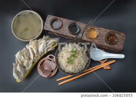 Steamed chicken with rice (Hainanese chicken rice) is sprinkled with Coriander and Pork blood puddings, Winter melon Soup is served with various dipping sauce. Steamed chicken with rice (Hainanese chicken rice) is sprinkled with Coriander and Pork blood puddings, Winter melon Soup is served with various dipping sauce. 106825055
