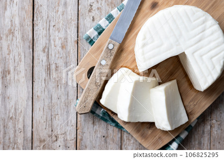 Sliced fresh white cheese from cow's milk on white background 106825295