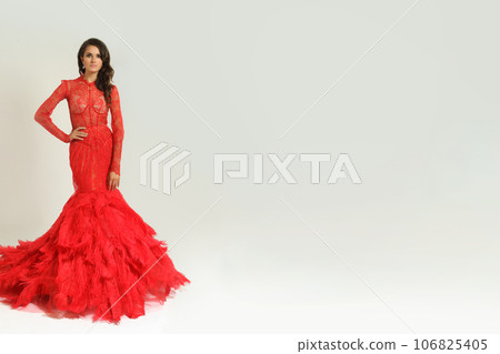 Fashion portrait of beautiful brunette model woman in red dress. Brunette glamour lady  106825405