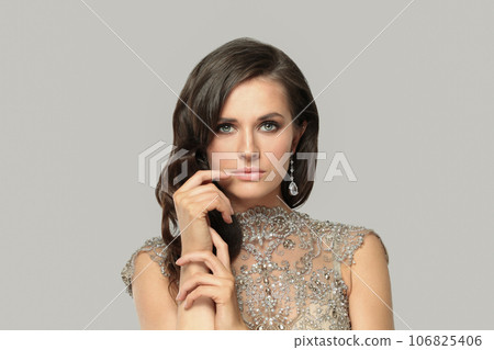 Elegant pretty good-looking brunette woman fashion model with makeup wearing diamond earring Elegant pretty good-looking brunette woman fashion model with makeup wearing diamond earring 106825406