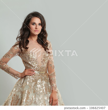 Beautiful woman model in elegant dress posing against white studio wall banner background 106825407