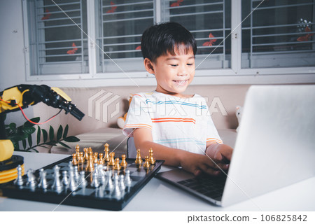 Asian little boy programming code to robot machine arm on laptop for play chess, STEM education E-learning, Funny children learning getting lesson control robot arm, Technology science education Asian little boy programming code to robot machine arm on laptop for play chess, STEM education E-learning, Funny children learning getting lesson control robot arm, Technology science education 106825842