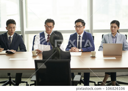 young asian job seeker being interviewed by a group of corporate business executives young asian job seeker being interviewed by a group of corporate business executives 106826106