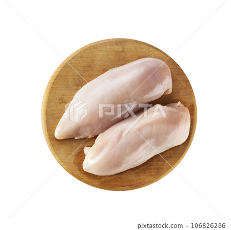 raw skinless chicken breast fillets on a cutting board isolated on white background, top view. 106826286