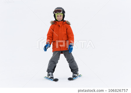 Kid boy on mountain ski against white snow background 106826757