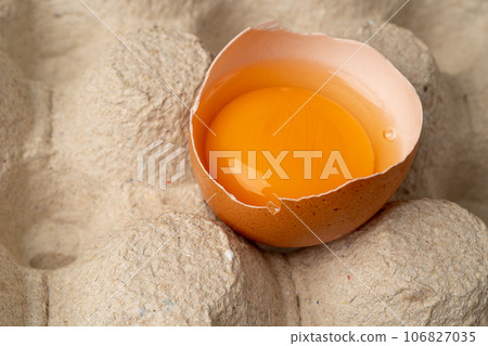 One Broken Chicken Egg, Broken Eggs in Carton Pack, Fresh Brown Hen Eggs Container One Broken Chicken Egg, Broken Eggs in Carton Pack, Fresh Brown Hen Eggs Container 106827035