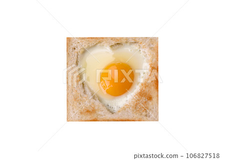 Heart shaped fried egg in bread toast with sesame seeds, flax seeds and pumpkin seeds on a black plate 106827518