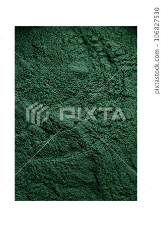 Spice, green color spirulina in the form of powder in a black bowl Spice, green color spirulina in the form of powder in a black bowl 106827530