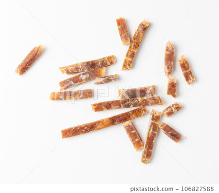 Fish Jerky Isolated, Dry Salted Seafood Snack, Hake Stockfish, Small Pieces of Dehydrated Pollock Fish Jerky Isolated, Dry Salted Seafood Snack, Hake Stockfish, Small Pieces of Dehydrated Pollock 106827588