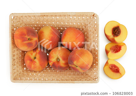 Ripe peach fruit with half in a wicker basket isolated on white background with full depth of field. Top view. Flat lay Ripe peach fruit with half in a wicker basket isolated on white background with full depth of field. Top view. Flat lay 106828003
