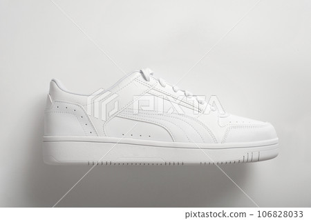 White sneaker on a white background with a shadow. 106828033