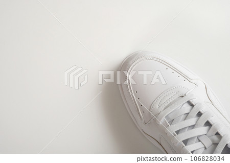 White sneaker on a gray background. Top view White sneaker on a gray background. Top view 106828034