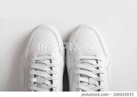 Pair of white sneakers on a white background, top view. Pair of white sneakers on a white background, top view. 106828035