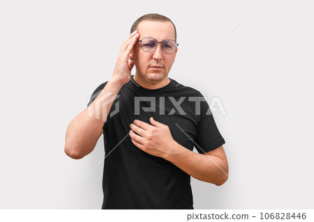 Young man with a headache on a light background. Health care and medicine Young man with a headache on a light background. Health care and medicine 106828446