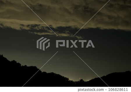 In Nagasaka Town, Hokuto, the lights of the hut leading up to the peak of Fuji approach at dusk. 106828611