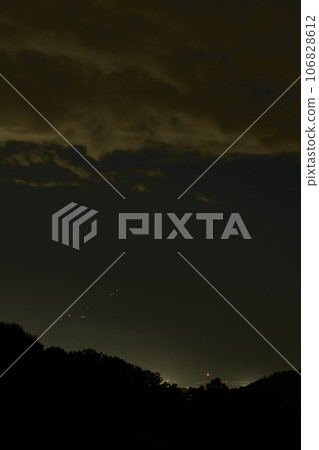 In Nagasaka Town, Hokuto, the lights of the hut leading up to the peak of Fuji approach at dusk. 106828612