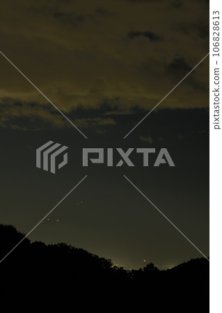 In Nagasaka Town, Hokuto, the lights of the hut leading up to the peak of Fuji approach at dusk. 106828613