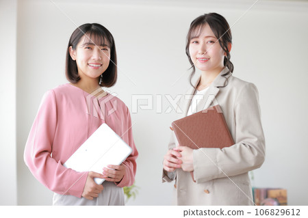 Two business women with tablets_1 Two business women with tablets_1 106829612