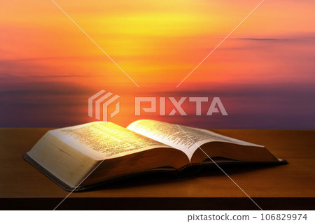 Open Bible on a black table with light coming from above. ( Church concept. ) 106829974